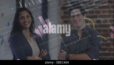 Statistical data processing against diverse male and female office colleagues smiling at office Stock Photo