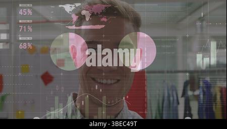 Statistical data processing against portrait of caucasian man smiling at office Stock Photo