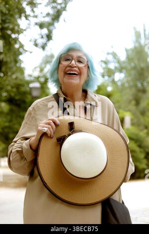 senior woman with blue hair very happy outdoors Stock Photo