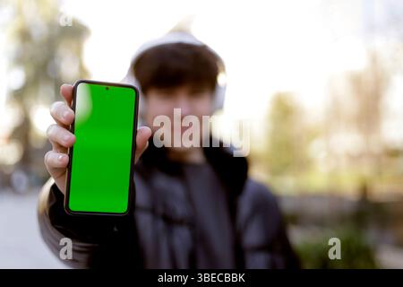 teenager showing cell phone screen to camera Stock Photo