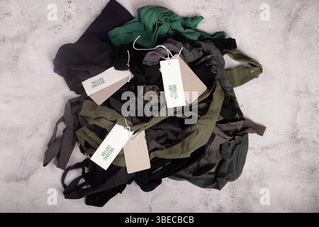cotton fabric in green tones with organic cotton labels Stock Photo