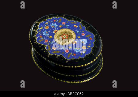 Oval wooden casket decorated in oriental style on a black background Stock Photo