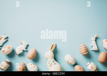 Floral painted Easter eggs in natural colors, decorative rabbits on pastel blue background. Happy Easter card. Stock Photo