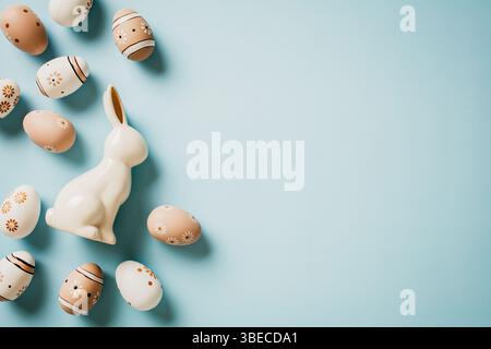 Elegant Easter card. Flat lay handmade Easter eggs and bunny on pastel blue background, Stock Photo