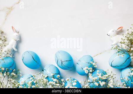 Blue and white Easter scene with a bunny, Easter eggs, spring flowers Stock Photo