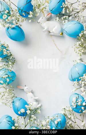 Blue and white Easter scene with two white rabbits and blue eggs. Flat lay, top view Stock Photo