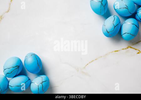 Blue Easter eggs on marble background. Flat lay, top view. Stock Photo