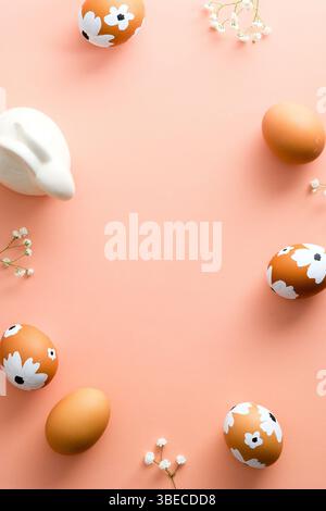 Painted Easter eggs and decorations on pastel pink background. Happy Easter vertical banner design, poster template. Stock Photo