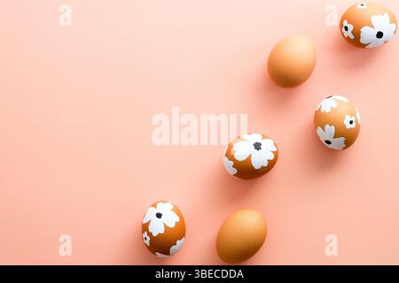 Easter Eggs decorated flowers on pastel pink background. Flat lay, top view. Stock Photo