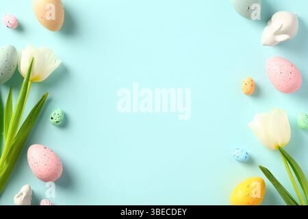 Happy Easter greeting card template. Double border frame made of colorful Easter eggs, tulips, decorative bunny. Stock Photo