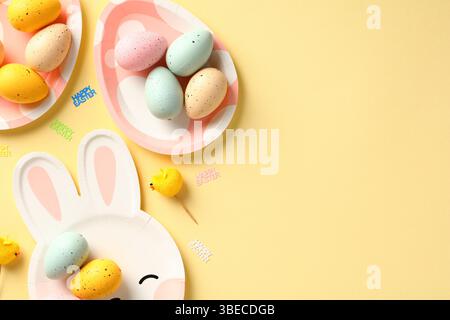 Happy Easter flat lay composition with colorful Easter eggs on cute plates. Stock Photo