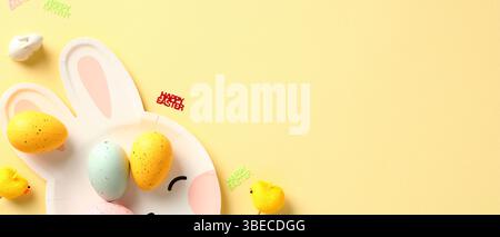 Happy Easter banner with bunny plate and colorful Easter eggs on yellow background. Stock Photo