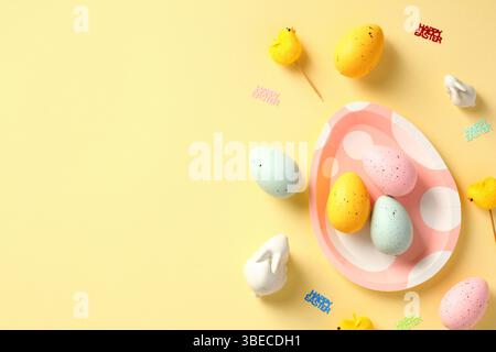 Happy Easter banner design. Easter eggs, bunny, decorations on yellow table. Stock Photo