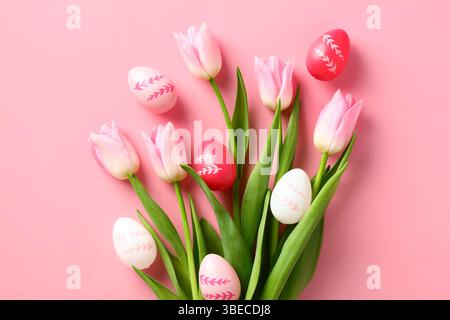 Bouquet of tulips and Easter eggs on pastel pink background Stock Photo