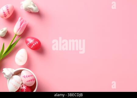Happy Easter concept. Easter card with eggs, bunnies and tulips on a pink background. Stock Photo