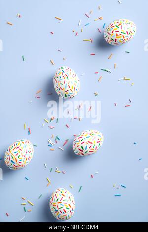 Colorful easter eggs on pastel blue background. Flat lay composition, view from above. Stock Photo