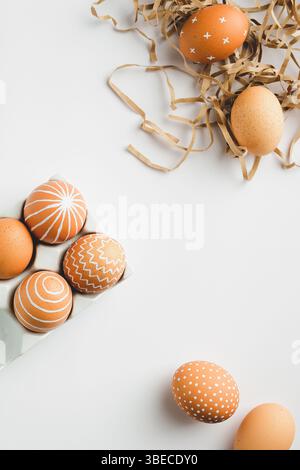 Simple Easter eggs on white background. Happy Easter vertical banner mockup. Flat lay, top view. Nordic style. Stock Photo