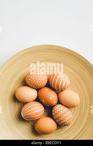 Simple Easter eggs on elegant plate on white background. Happy Easter concept. Stock Photo