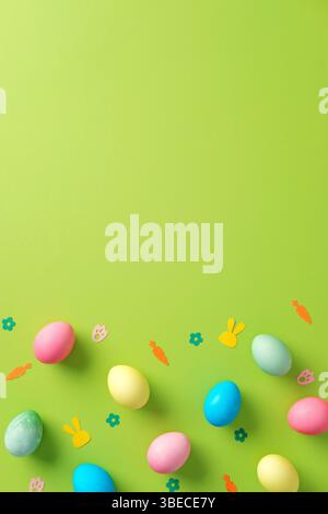 Happy Easter concept. Flat lay composition with colorful eggs and confetti on bright green background. Stock Photo