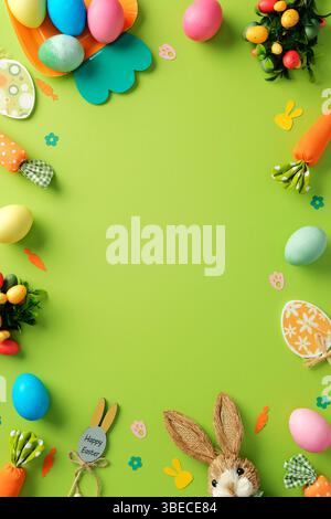 Easter vertical background. Frame border of Colorful painted Easter eggs, bunny, festive decoration, on vibrant green background. Easter banner design Stock Photo