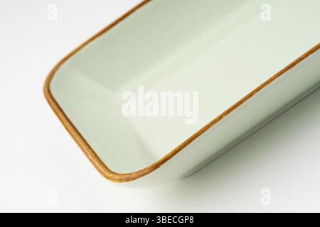 A one ceramic green rectangular plate isolated on white background Stock Photo