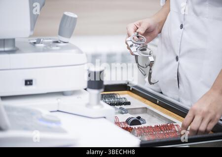Woman doctor holds in his hands the optical test lenses for testing vision. medical concept Stock Photo