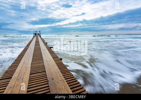 Beautiful seascape after sunset, waves blurred by long exposure Stock Photo