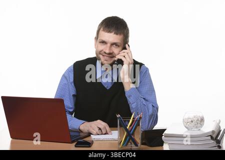 Entrepreneur talks on the phone at the desk on a white background Stock Photo
