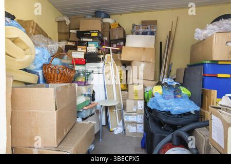 Moving, things packed in boxes and packages lie in a small room Stock Photo
