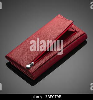 Fashionable red leather women's wallet on a dark background Stock Photo