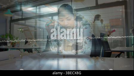 Image ofdata processing against african american female engineer working on her model at office Stock Photo