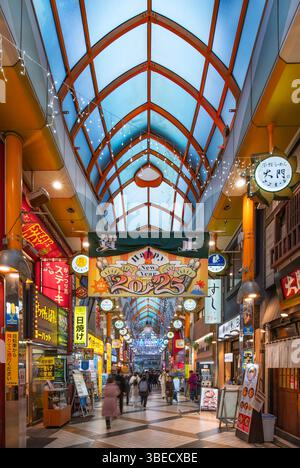 tokyo, nakano - jan 08 2025: Japanese New Year decorations illuminate Nakano’s covered shopping street, where festive banners and neon signs hang abov Stock Photo