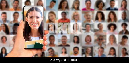 A person holds a smartphone displaying a facial recognition scan Stock Photo