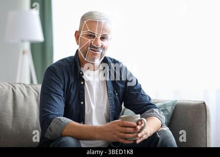 Modern facial recognition technology in use during daily routine at home Stock Photo
