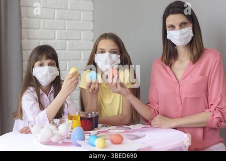 Quarantined family paints eggs for easter Stock Photo