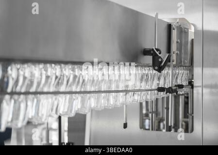 Empty plastic bottles on conveyor belt. equipment at the dairy plant Stock Photo