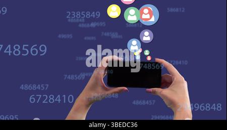 Multiple profile icons floating and changing numbers over hand holding a smartphone Stock Photo