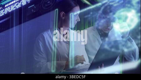 Data processing against diverse male and female engineers using laptop at computer server room Stock Photo
