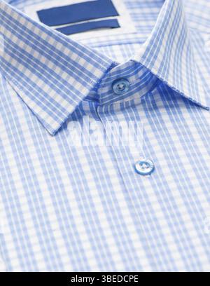 Blue shirt with checkered pattern and with a focus on the collar and button, close-up Stock Photo
