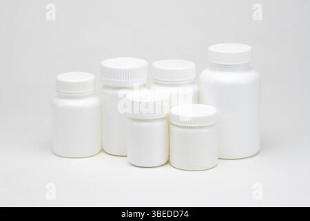 White plastic pill jars on a white background. Isolated Stock Photo