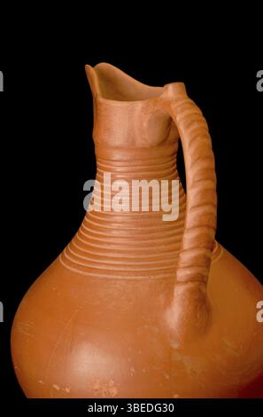 A brown clay jug isolated on a black background Stock Photo