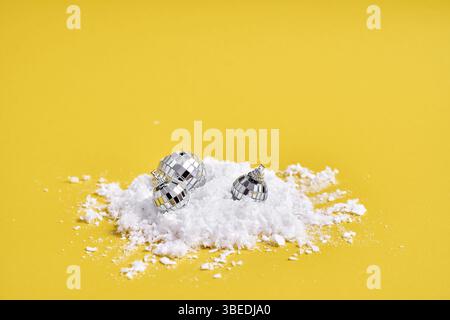 Red white alarm clock with snow on yellow background and podium for product. Creative Christmas sale. Stock Photo