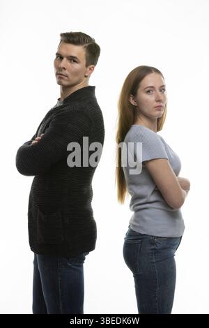The couple got into a fight and standing with their backs to each other in the frame Stock Photo