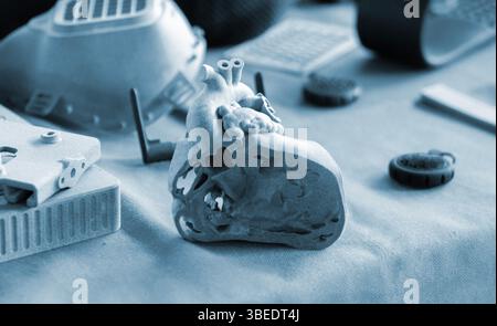 A prototype of a human heart in section printed on a 3D printer. An object created on a 3D printer from sintered plastic powder. New modern additive technologies. 3D Printing technology Stock Photo