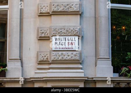 Street sign for Whitehall Place in the City of Westminster, London. The sign displays the SW1 postal code. Stock Photo