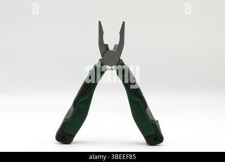 Multi tool with multiple functions and pliers on white background. Stock Photo