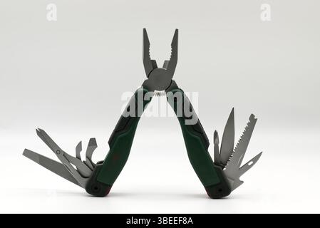 Multi tool with multiple functions and pliers isolated on white background. Stock Photo