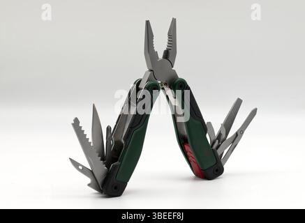 Multi tool with multiple functions and pliers isolated on white. Stock Photo