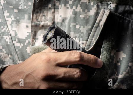 The man holding a LED flashlight in hand. Stock Photo