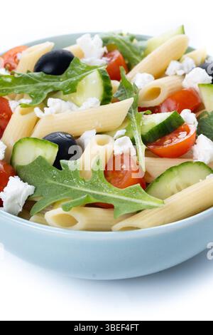 Mediterranean Pasta Salad in bowl with Fresh Vegetables and Herbs isolated on white background. Stock Photo